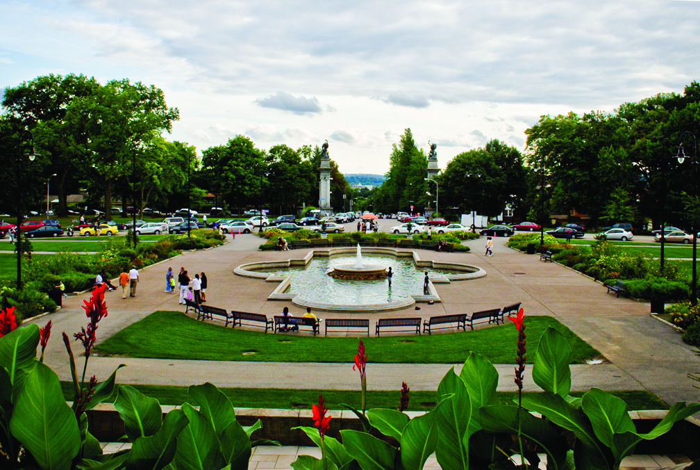 Highland Park fountain and greenery with people walking