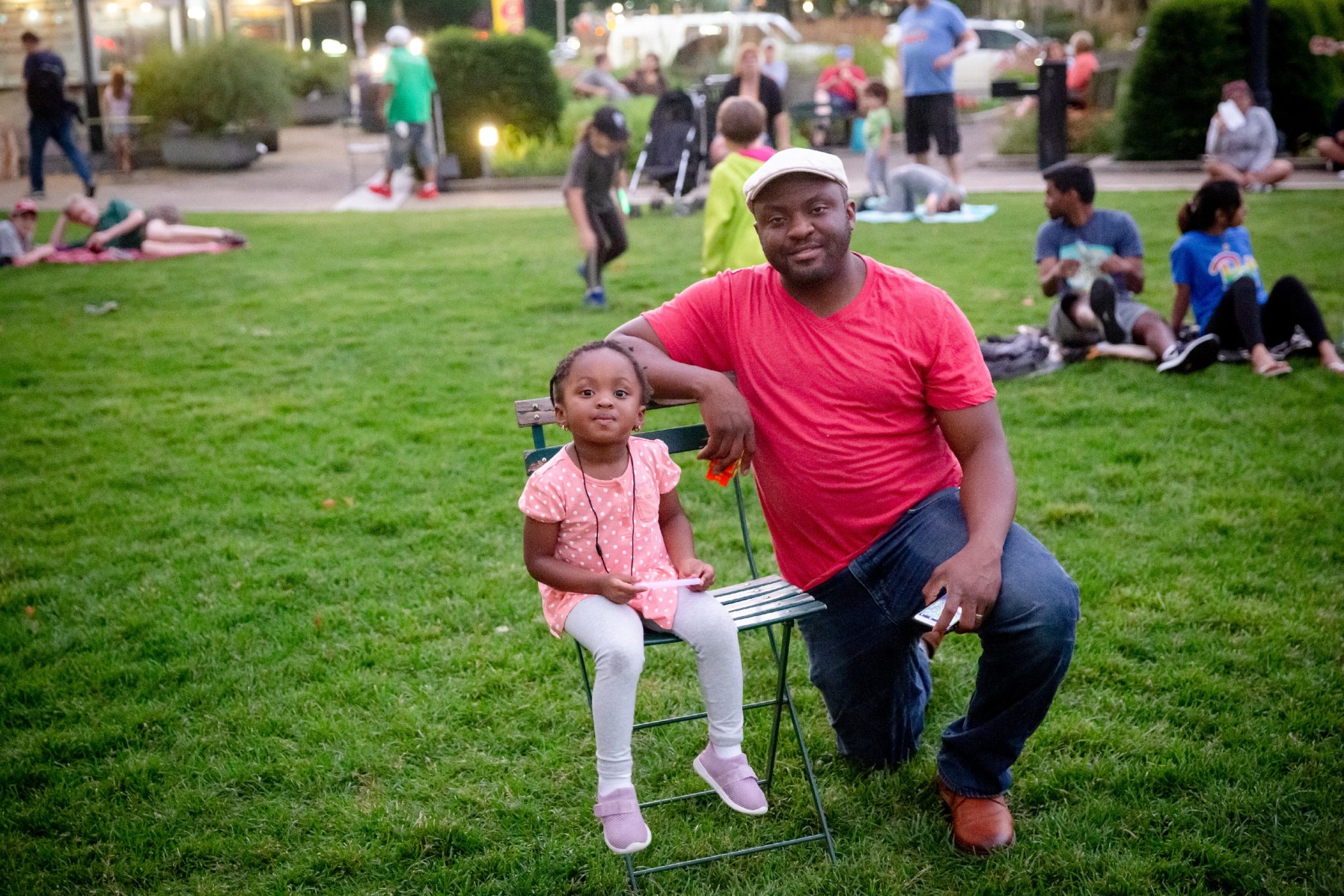 Man and child sitting in Schenley Plaza