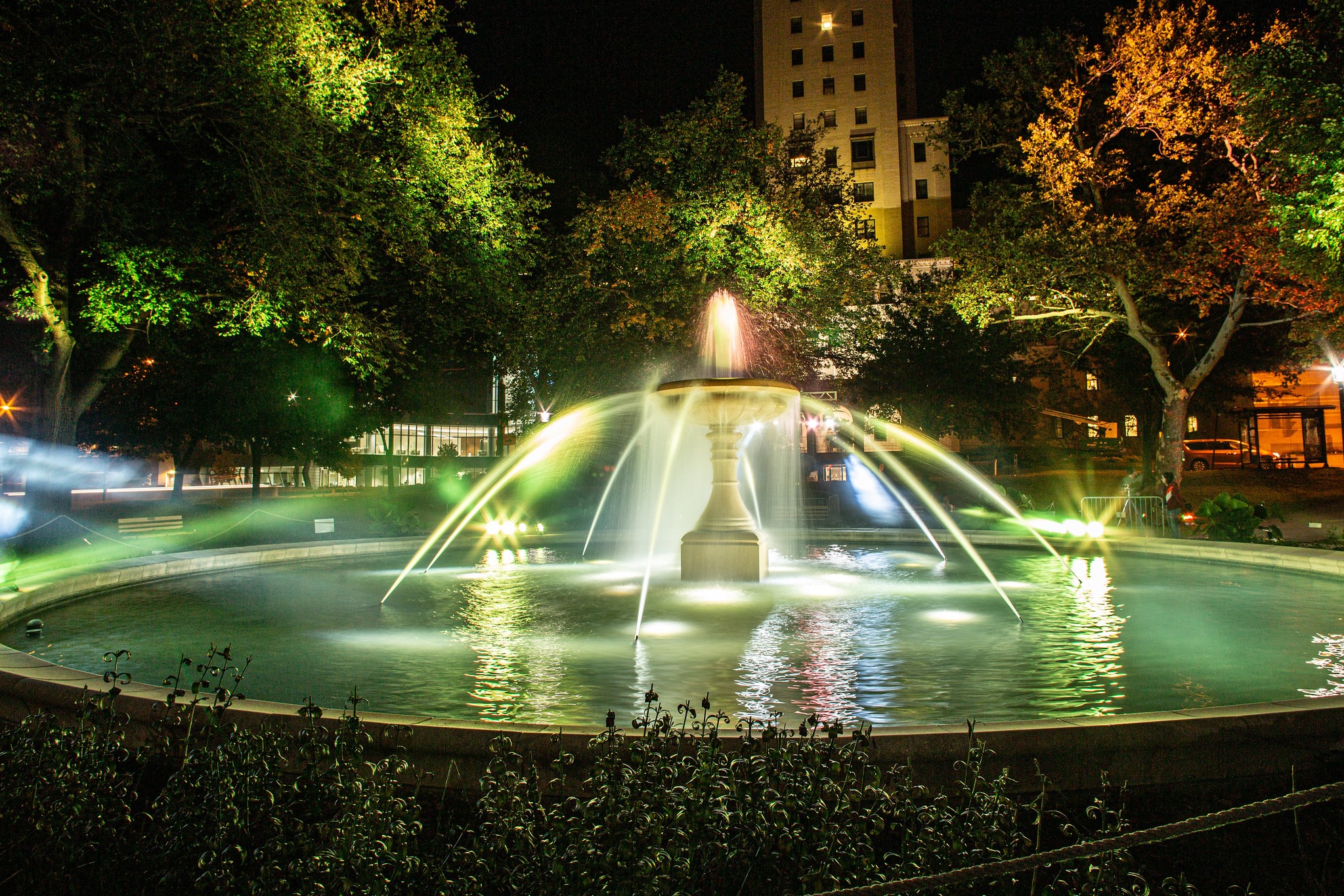 The Rooney Memorial Fountain illuminated in the evening.