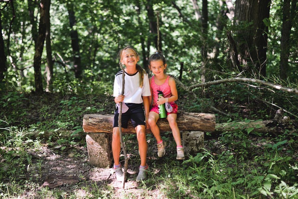 Two children sitting on a log