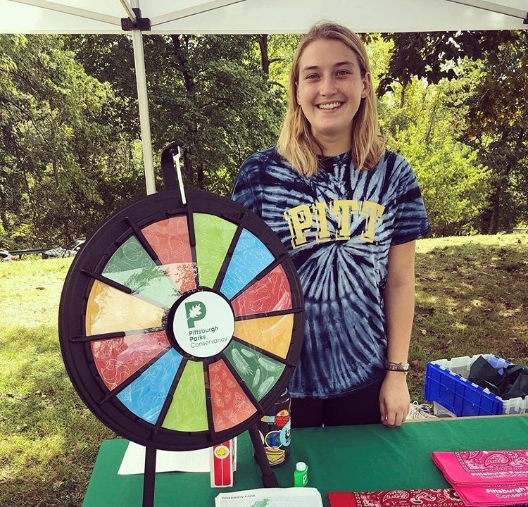 Volunteer in front of a PPC wheel game