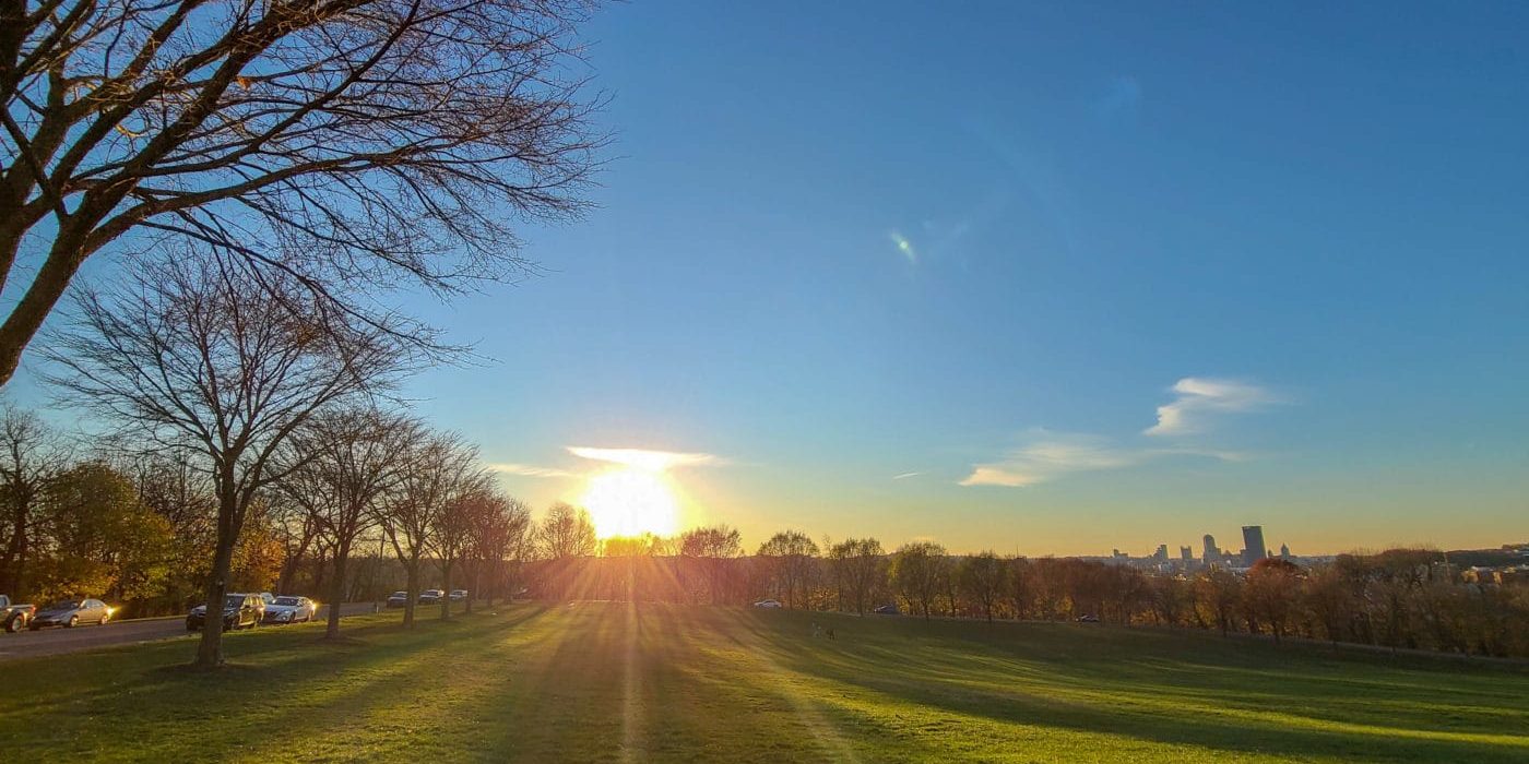Image of Schenley Park with the sun setting behind it